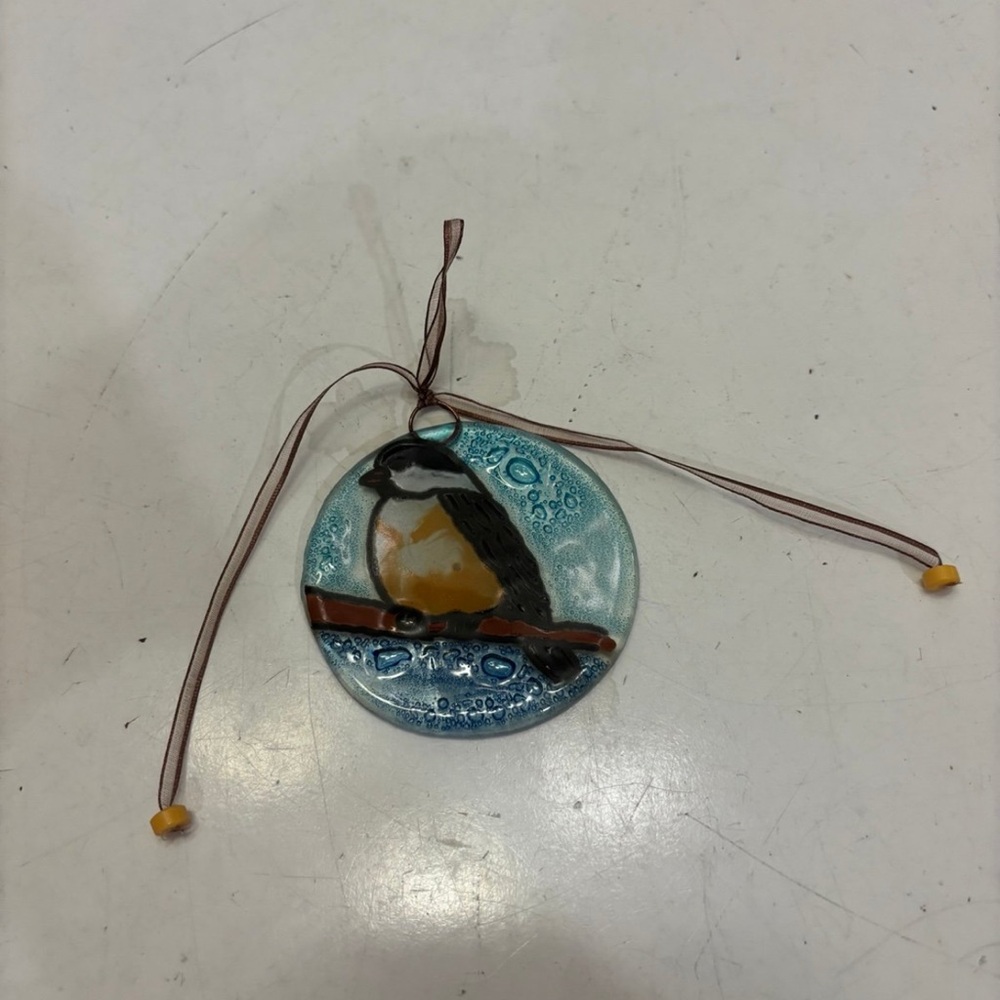 Hand painted art glass ornament of bird on a branch